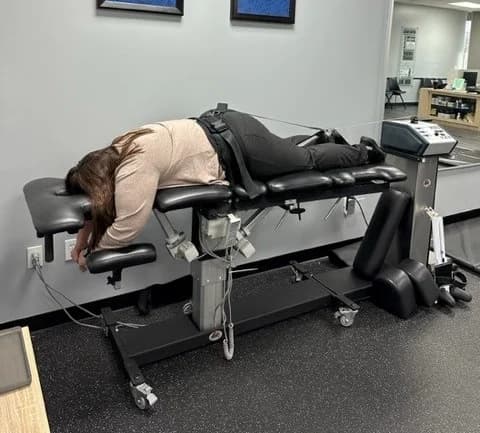 Patient lying on the spinal decompression table at Breakaway Chiropractic in Frisco, TX